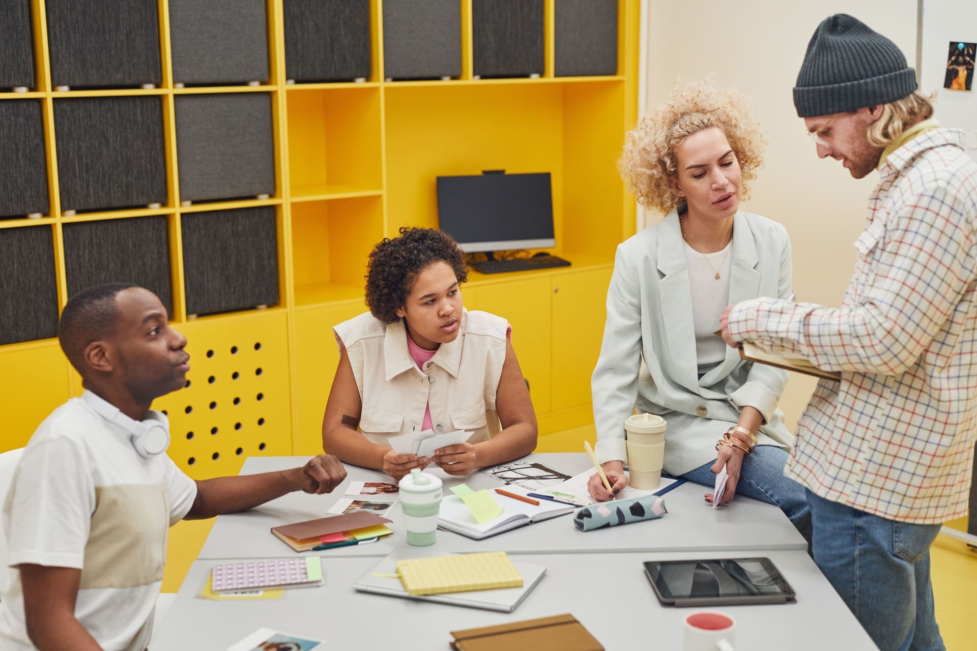 Team members collaborating around a tablet